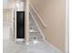 Basement staircase featuring modern marble-style tile, illuminated steps and neutral walls at 1249 S Irving St, Denver, CO 80219