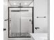 Bathroom shower with black metal frame and patterned tile flooring at 1249 S Irving St, Denver, CO 80219