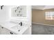 Bright bathroom featuring a marble vanity and modern fixtures at 1249 S Irving St, Denver, CO 80219