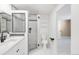 Modern bathroom with glass shower, black fixtures, and floating shelves at 1249 S Irving St, Denver, CO 80219