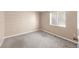 Bedroom with neutral carpeting, window with blinds, and tan painted walls at 1249 S Irving St, Denver, CO 80219
