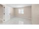 Bedroom with tile flooring, window with blinds, and a white door at 1249 S Irving St, Denver, CO 80219