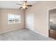 Bedroom with ceiling fan, carpet, closet and a large window at 1249 S Irving St, Denver, CO 80219