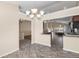 Bright dining area with tile flooring, modern chandelier, and views into the kitchen and living areas at 1249 S Irving St, Denver, CO 80219