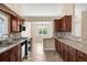 Well-equipped kitchen featuring granite countertops, cherry wood cabinets, and stainless steel appliances at 1249 S Irving St, Denver, CO 80219
