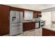 Beautiful kitchen with stainless steel appliances, dark wood cabinets, and granite countertops at 1249 S Irving St, Denver, CO 80219