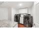 Bright laundry room features granite countertops and stainless steel appliances at 1249 S Irving St, Denver, CO 80219
