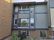 Building exterior featuring a gray and brick facade, with balconies, and windows at 850 W Moorhead Cir # 3F, Boulder, CO 80305