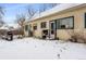 The backyard has snow cover with a grill and a small back porch or deck at 4151 Zenobia St, Denver, CO 80212