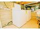 Basement with washer and dryer units set against a textured wall and concrete flooring at 4151 Zenobia St, Denver, CO 80212