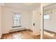 A bright bedroom with wood floors features a window and a mirrored closet at 4151 Zenobia St, Denver, CO 80212