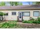 Rear exterior of the home featuring blue trim windows and door with yard views at 4151 Zenobia St, Denver, CO 80212