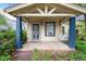 Inviting covered porch with decorative columns and a swing, perfect for relaxing outdoors at 4151 Zenobia St, Denver, CO 80212