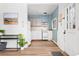 Charming kitchen featuring blue walls, light wood floors, and white appliances and cabinetry at 4151 Zenobia St, Denver, CO 80212