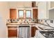 The kitchen features white and wood cabinets and unique backsplash at 4151 Zenobia St, Denver, CO 80212
