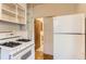 A compact kitchen offers essential appliances and access to the bathroom at 4151 Zenobia St, Denver, CO 80212