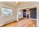 Light-filled living room with hardwood floors and views into a kitchen space at 4151 Zenobia St, Denver, CO 80212