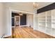 An open-concept living area with hardwood floors and custom built-in shelving at 4151 Zenobia St, Denver, CO 80212