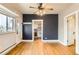 An open-plan living room with hardwood floors and views into the kitchen at 4151 Zenobia St, Denver, CO 80212