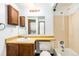 Functional bathroom featuring a vanity, tub/shower combo, and convenient access to an in-unit laundry area at 922 S Dearborn Way # 8, Aurora, CO 80012