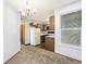 Bright dining area with updated lighting, neutral carpet, and a view into the kitchen, perfect for entertaining at 922 S Dearborn Way # 8, Aurora, CO 80012