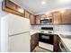 Efficient kitchen showcasing wood-look flooring, modern appliances, and ample counter space for meal preparation at 922 S Dearborn Way # 8, Aurora, CO 80012