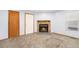 Cozy living room featuring a stone fireplace, neutral carpet, and a window for ample natural light at 922 S Dearborn Way # 8, Aurora, CO 80012