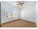 Charming bedroom with two windows and ceiling fan at 851 Lonewolf Cir, Lochbuie, CO 80603