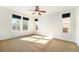 Spacious bedroom featuring three windows and ceiling fan at 851 Lonewolf Cir, Lochbuie, CO 80603