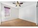 Well-lit bedroom with ceiling fan and large window at 851 Lonewolf Cir, Lochbuie, CO 80603