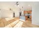 Sunlit living room features hardwood floors and high ceilings at 851 Lonewolf Cir, Lochbuie, CO 80603