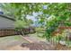 Spacious backyard features a wooden fence, a small garden and a brick path at 17605 Ponderosa Ave, Parker, CO 80134