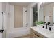Modern bathroom with stylish black fixtures, neutral-toned tile, and a vanity with a sink at 17605 Ponderosa Ave, Parker, CO 80134