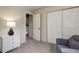 Bedroom featuring a stylish chair, sliding closet doors, and modern white dresser at 17605 Ponderosa Ave, Parker, CO 80134