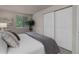 Comfortable bedroom featuring a queen-sized bed, sliding closet doors, and a view of outside at 17605 Ponderosa Ave, Parker, CO 80134