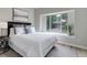 Bright bedroom with large window, cozy bed, and tranquil decor at 17605 Ponderosa Ave, Parker, CO 80134