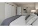 Bedroom featuring a queen-sized bed, sliding closet doors, and modern wall art at 17605 Ponderosa Ave, Parker, CO 80134