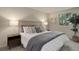 Bright bedroom featuring neutral tones, stylish lamps, and a comfortable queen-sized bed at 17605 Ponderosa Ave, Parker, CO 80134