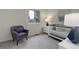 Bright Bedroom featuring a white crib, a comfortable chair, and a view of outside at 17605 Ponderosa Ave, Parker, CO 80134