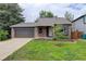 Charming home with a brick and siding exterior, garage, and well-manicured lawn at 17605 Ponderosa Ave, Parker, CO 80134