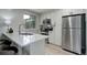 Bright kitchen features granite counters, stainless steel appliances, and white cabinets at 17605 Ponderosa Ave, Parker, CO 80134