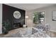 Well-lit living room features wood floors, statement fireplace wall, and modern furniture at 17605 Ponderosa Ave, Parker, CO 80134
