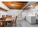 Unfinished basement area with washer, dryer and exposed wood ceiling beams at 8979 Field St # 27, Westminster, CO 80021