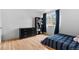 Bedroom with blue striped bedding, hardwood floors and natural light from the window at 8979 Field St # 27, Westminster, CO 80021