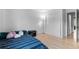 Cozy bedroom with blue striped bedding and hardwood floors with a view to the hallway at 8979 Field St # 27, Westminster, CO 80021