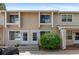 Tan two-story townhouse with well-manicured front yard and partial car view at 8979 Field St # 27, Westminster, CO 80021