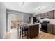 Modern kitchen featuring wood floors, an island, black appliances and sliding door at 8979 Field St # 27, Westminster, CO 80021