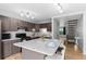 Bright kitchen featuring wood floors, an island, stainless appliances and access to stairs at 8979 Field St # 27, Westminster, CO 80021