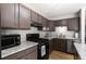 Modern kitchen with stainless steel appliances, wood floors and light countertops at 8979 Field St # 27, Westminster, CO 80021
