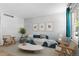 Bright living room with a blue sofa, modern decor, and large window at 8979 Field St # 27, Westminster, CO 80021